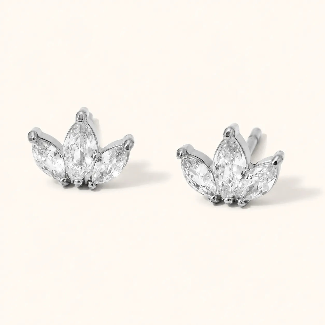 Three-stone marquise clear stud earrings in a lotus-inspired shape, available in polished stainless steel.